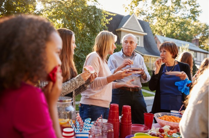 Neighbours sharing food together on the street