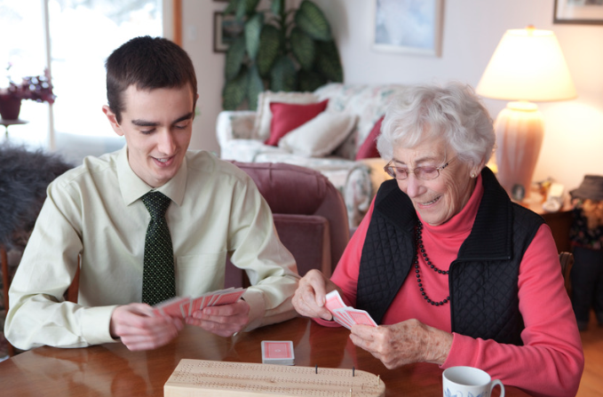 Grandson playing cards with grandmother